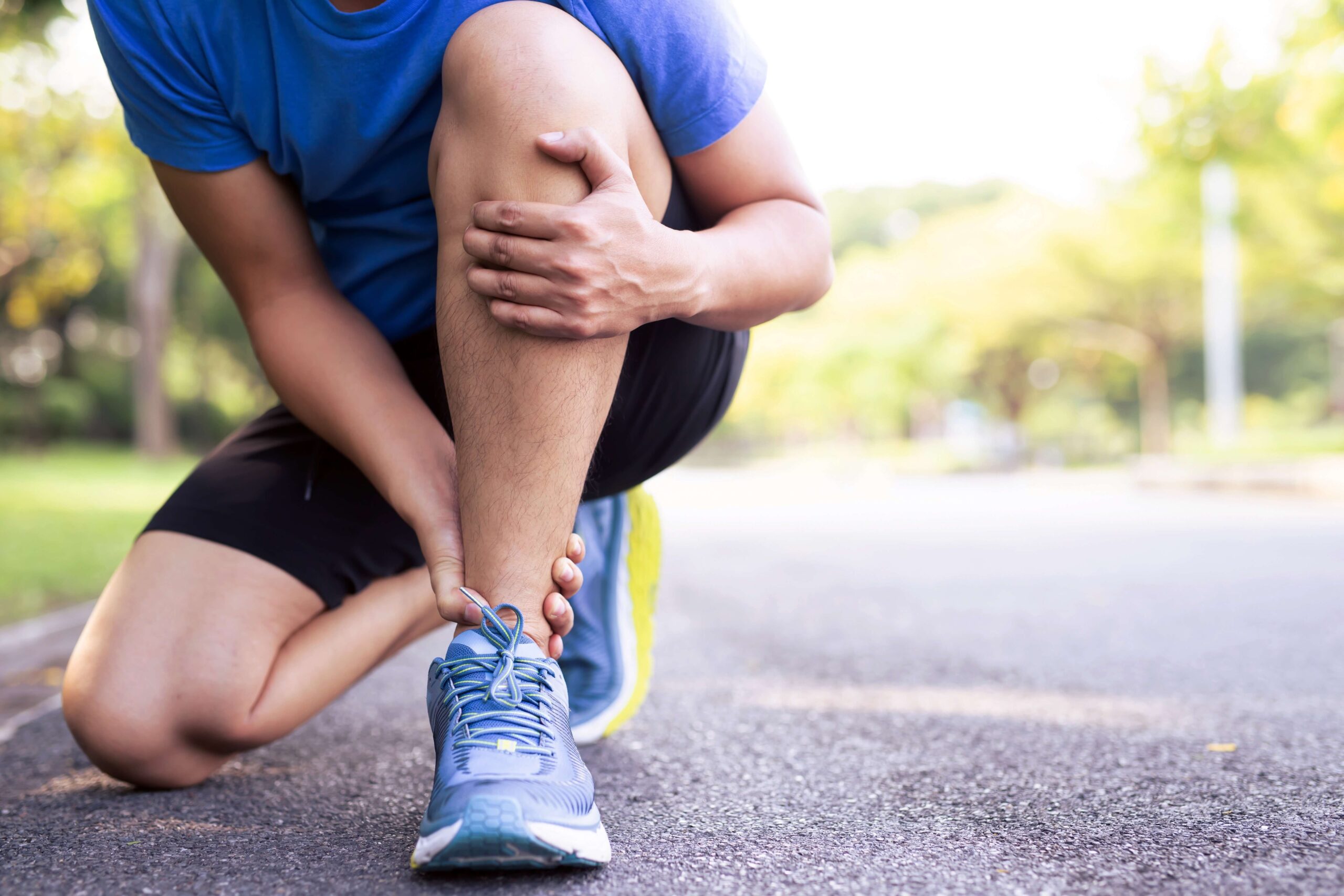 Male runners hurt their knees from a heavy stroke at the park.