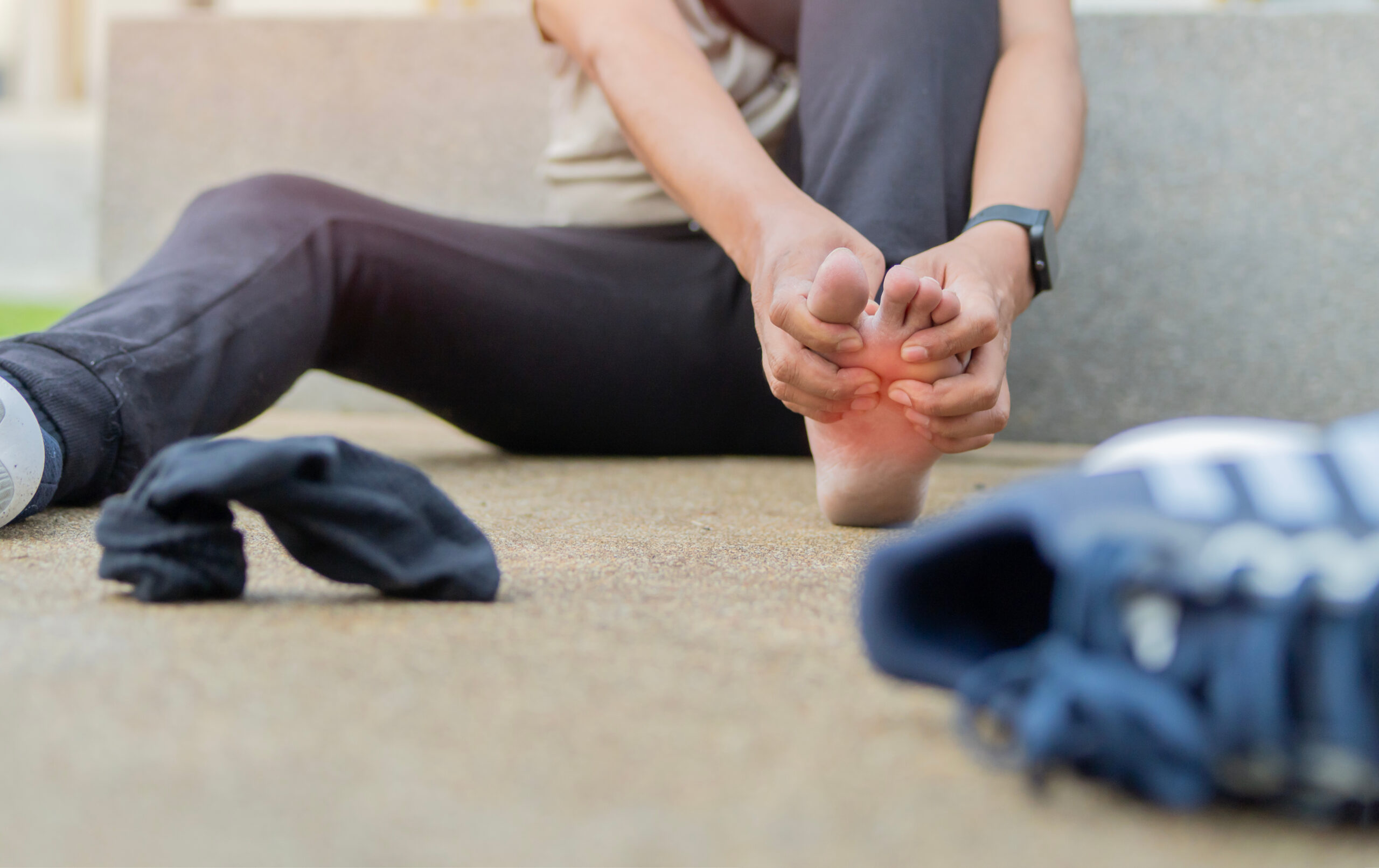 A sportsman runner suffering painful damaged foot, feel ache muscle cramp pain hurt sport trauma A sportsman runner suffering painful damaged foot, feel ache muscle cramp pain hurt sport trauma