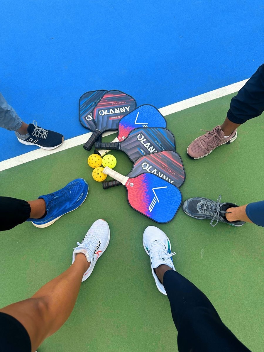 Friends with pickleball paddles on the court